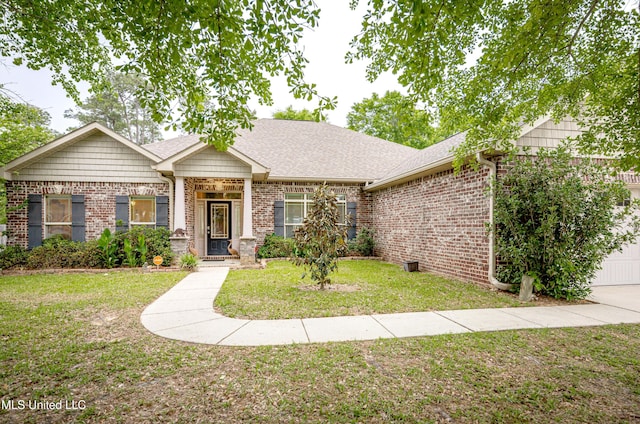 view of front of home with a shingled roof, brick siding, and a front yard