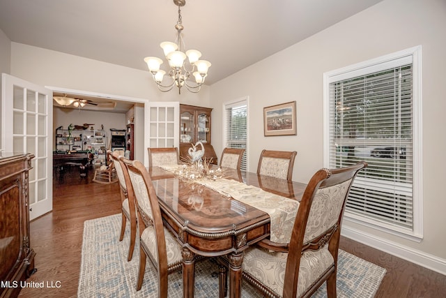 dining room featuring baseboards, dark wood-style floors, and an inviting chandelier