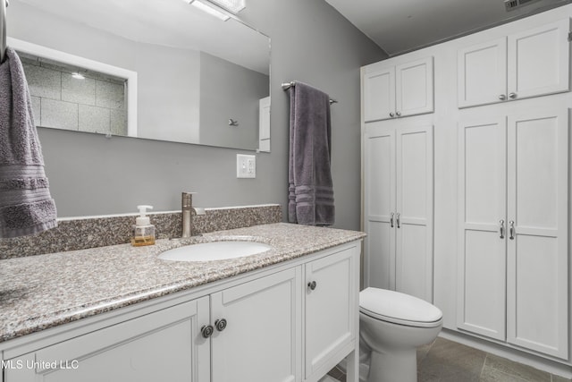 bathroom featuring vanity and toilet