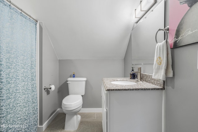 bathroom with vanity, vaulted ceiling, tile patterned floors, and toilet