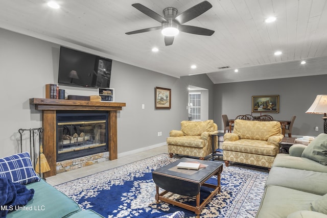 living room with vaulted ceiling, light tile patterned flooring, ceiling fan, and wood ceiling