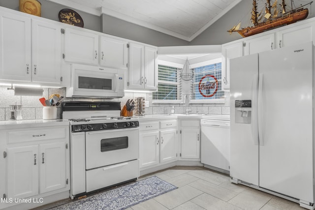 kitchen with sink, white cabinetry, tasteful backsplash, vaulted ceiling, and white appliances