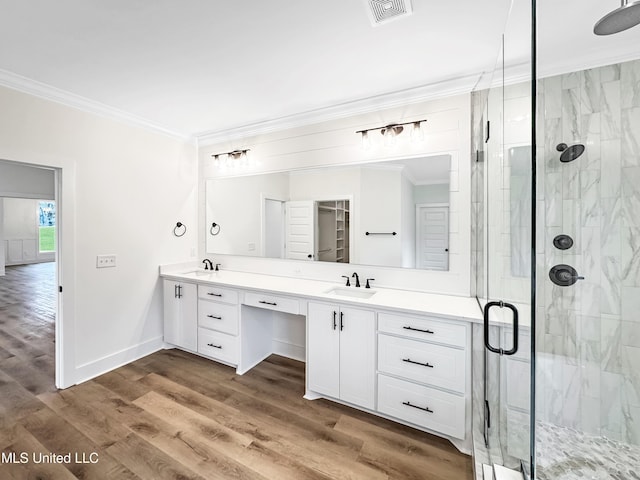 949 Mullican Rd, Florence, MS 39073 - bathroom featuring crown molding, double vanity, a stall shower, wood finished floors, and baseboards