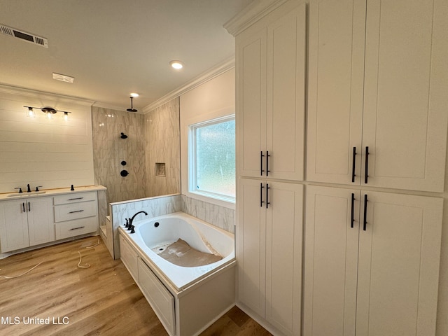 bathroom featuring vanity, hardwood / wood-style floors, crown molding, and plus walk in shower