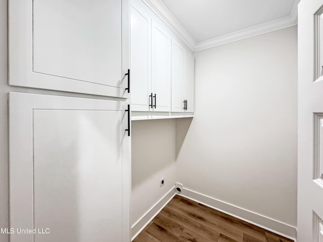 949 Mullican Rd, Florence, MS 39073 - laundry area featuring crown molding, baseboards, dark wood-style flooring, electric dryer hookup, and cabinet space