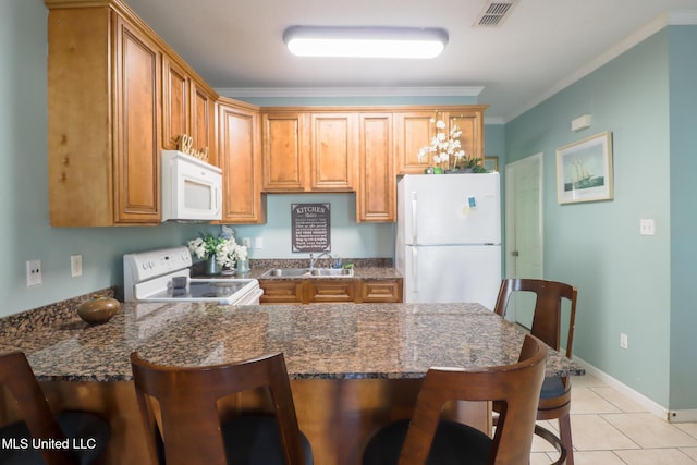 kitchen featuring ornamental molding, white appliances, sink, light tile patterned floors, and dark stone countertops