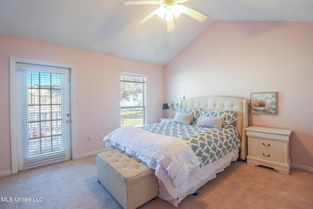 bedroom with multiple windows, ceiling fan, lofted ceiling, and access to exterior