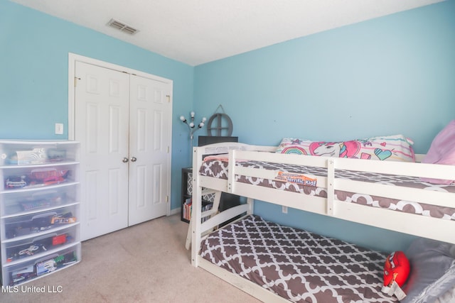 bedroom with light carpet and a closet