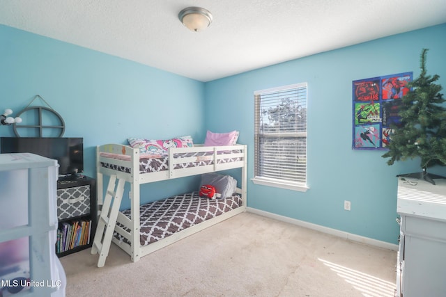 carpeted bedroom with a textured ceiling