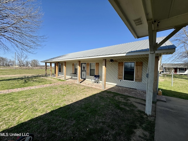 126 Interstate Rd, Shaw, MS 38773 - back of house with a lawn and metal roof