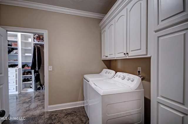 washroom featuring crown molding, baseboards, cabinet space, a textured ceiling, and separate washer and dryer