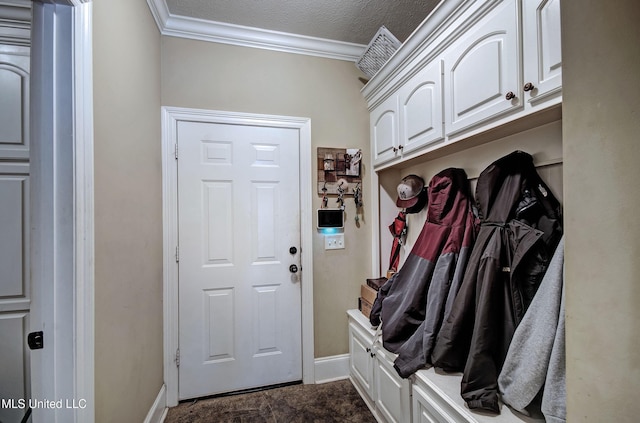 mudroom with baseboards, a textured ceiling, and ornamental molding