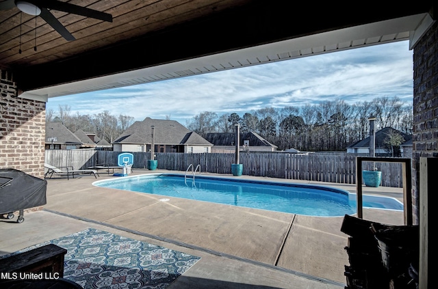 view of swimming pool with a patio area, ceiling fan, a fenced backyard, and a fenced in pool