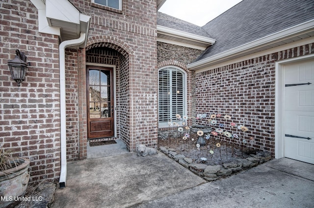 property entrance with brick siding and roof with shingles