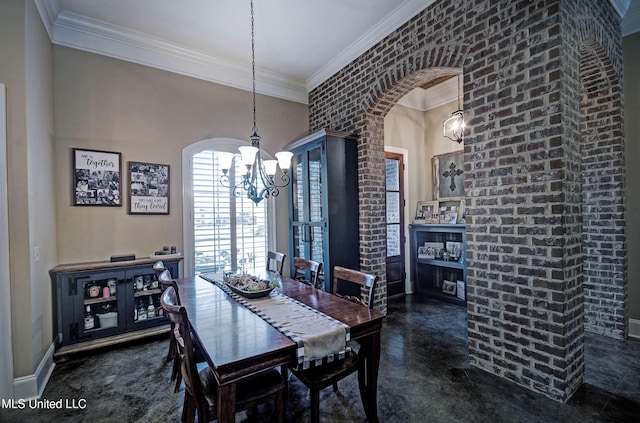 dining area with crown molding, baseboards, arched walkways, and a chandelier