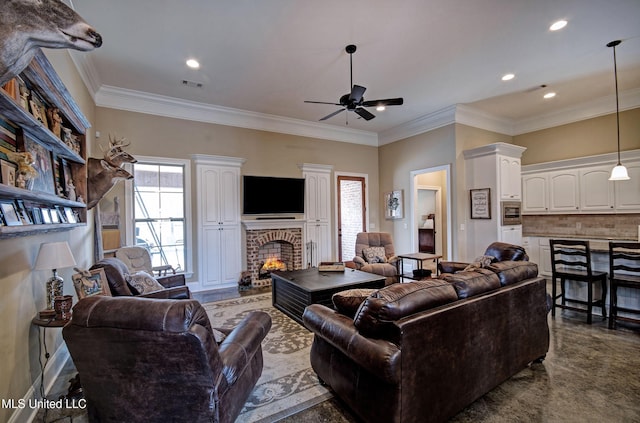 living area with visible vents, a brick fireplace, ornamental molding, recessed lighting, and a ceiling fan