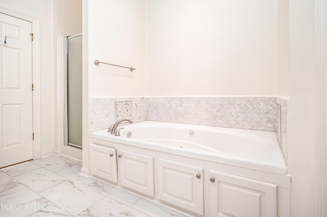 full bathroom with a garden tub, marble finish floor, and a stall shower