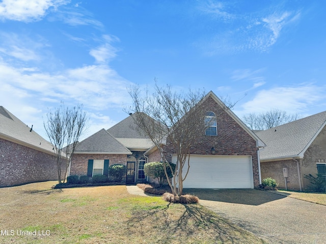 traditional-style house featuring brick siding, driveway, a front lawn, and a garage