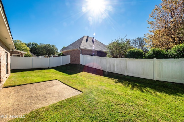 view of yard with a patio and a fenced backyard