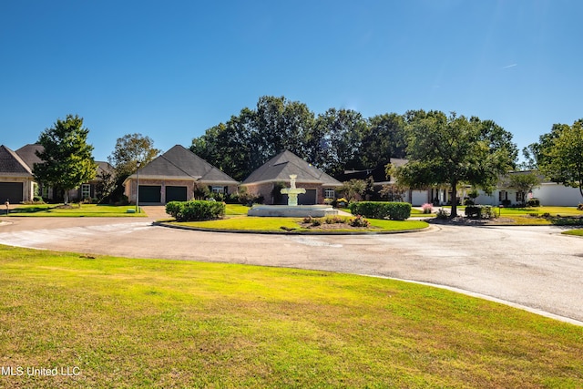 view of front facade with a front yard and driveway