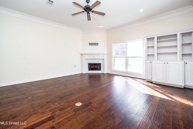 unfurnished living room with visible vents, a brick fireplace, baseboards, dark wood finished floors, and ornamental molding