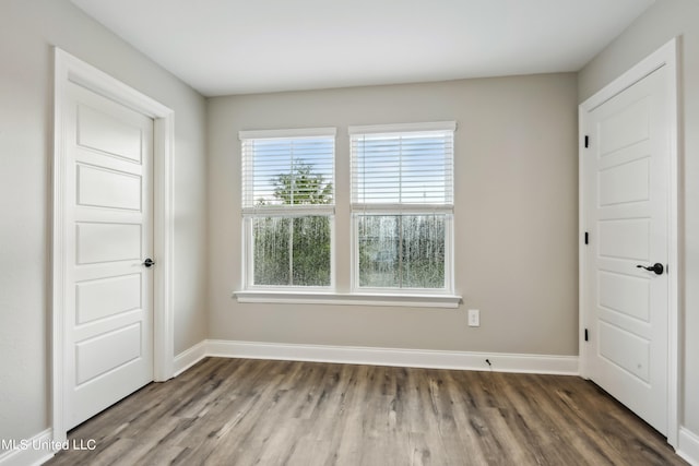 unfurnished bedroom with dark hardwood / wood-style floors