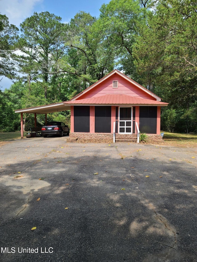 112 Lott Rd, Perkinston, MS 39573 - view of front of home featuring an attached carport, metal roof, and asphalt driveway
