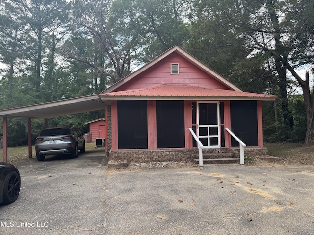 112 Lott Rd, Perkinston, MS 39573 - view of outdoor structure featuring a carport, entry steps, and driveway