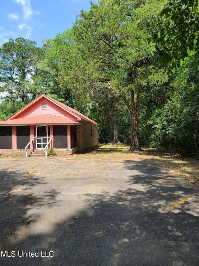 112 Lott Rd, Perkinston, MS 39573 - view of front of house with entry steps, metal roof, and a sunroom