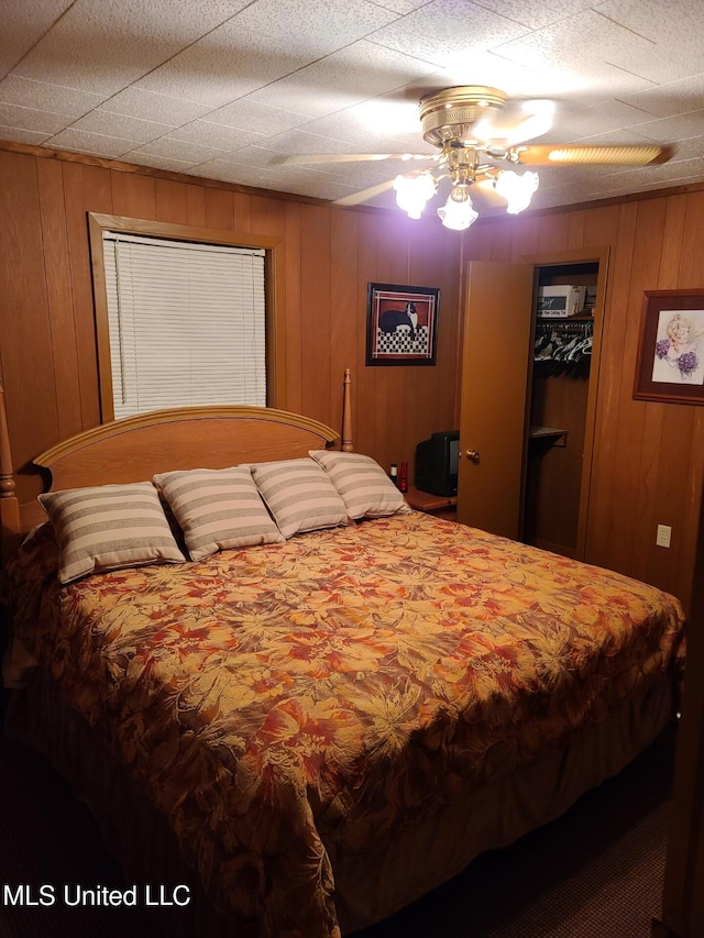 112 Lott Rd, Perkinston, MS 39573 - bedroom featuring wooden walls, a ceiling fan, a walk in closet, and a closet