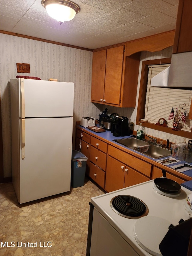 112 Lott Rd, Perkinston, MS 39573 - kitchen featuring white appliances, wallpapered walls, a sink, brown cabinetry, and dark countertops
