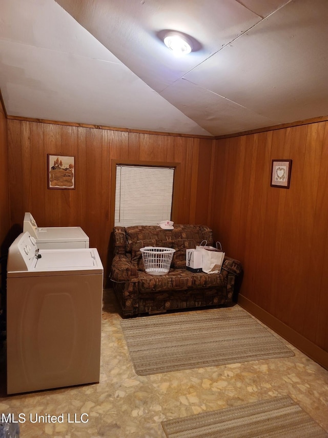 112 Lott Rd, Perkinston, MS 39573 - living room with lofted ceiling, wooden walls, and washing machine and clothes dryer