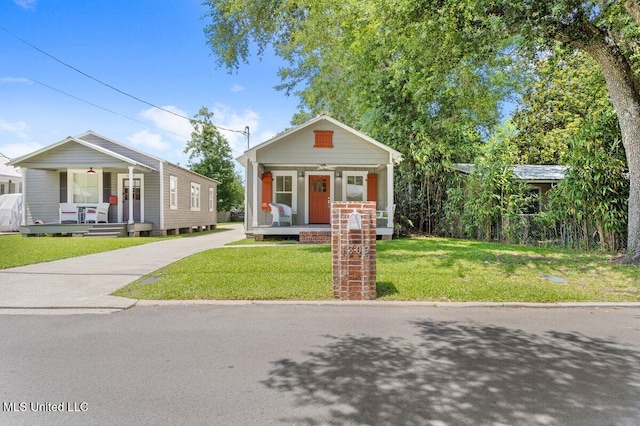 1309 Bowen Ave, Ocean Springs, MS 39564 - view of front of home featuring covered porch, a front lawn, and driveway