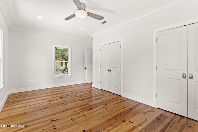 1309 Bowen Ave, Ocean Springs, MS 39564 - unfurnished bedroom with crown molding, multiple closets, light wood-style flooring, baseboards, and a ceiling fan