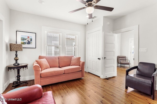 1309 Bowen Ave, Ocean Springs, MS 39564 - living area with a ceiling fan, light wood-style floors, and baseboards