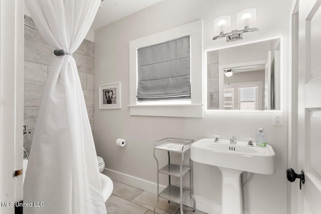 1309 Bowen Ave, Ocean Springs, MS 39564 - bathroom with toilet, a ceiling fan, a sink, tile patterned flooring, and a shower with curtain