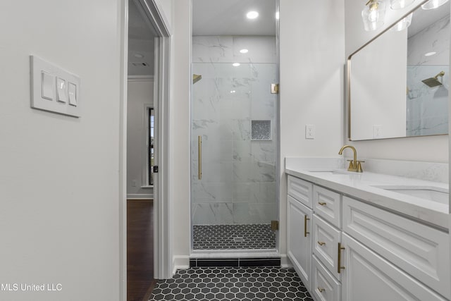 bathroom featuring tile patterned floors, a shower with door, and vanity