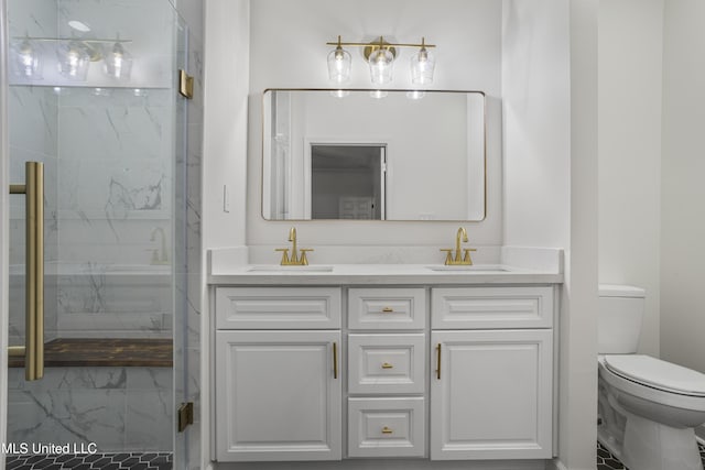 bathroom with a shower with door, vanity, and toilet