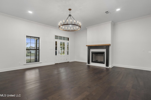 unfurnished living room with a notable chandelier, dark hardwood / wood-style flooring, and ornamental molding