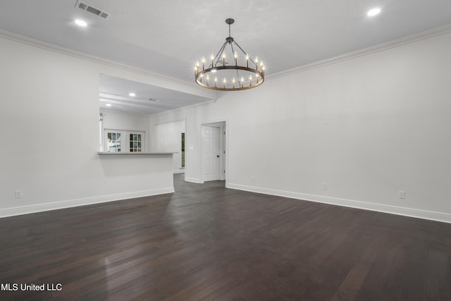 unfurnished room with dark wood-type flooring, crown molding, and a chandelier