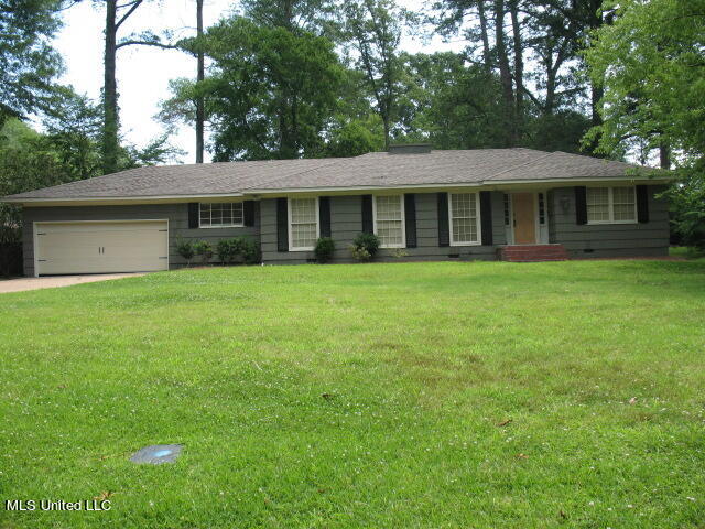 single story home featuring a front yard and a garage