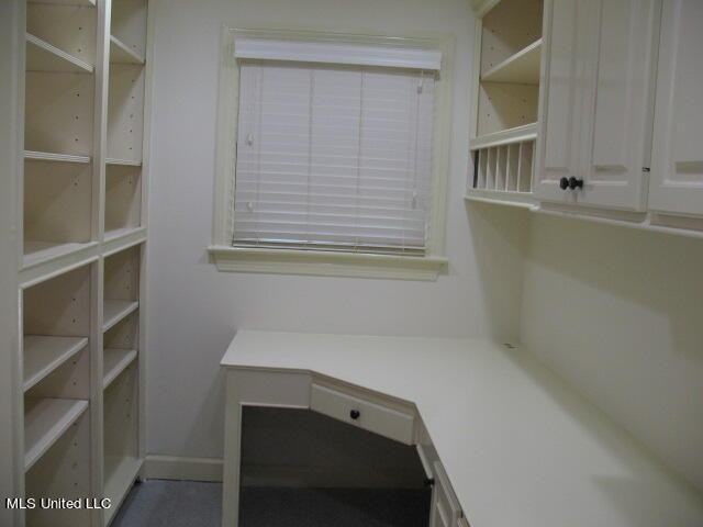 walk in closet featuring built in desk