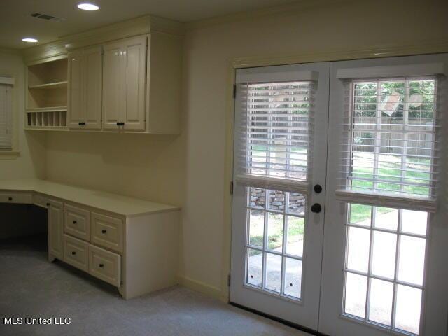 doorway to outside with french doors, baseboards, built in study area, light carpet, and recessed lighting