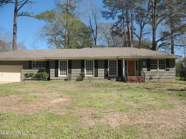 single story home featuring a front yard, a shingled roof, and a garage