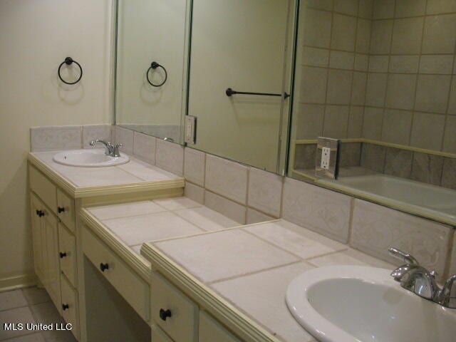 bathroom with vanity, tile patterned floors, and decorative backsplash