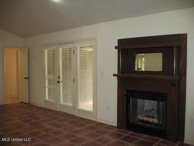 unfurnished living room featuring lofted ceiling and a multi sided fireplace