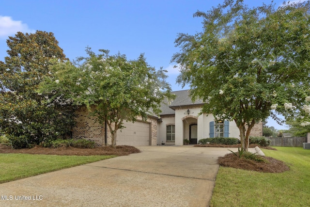 117 Belle Ct, Madison, MS 39110 - french country style house with concrete driveway, an attached garage, brick siding, and stucco siding