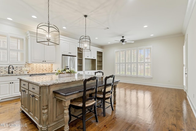117 Belle Ct, Madison, MS 39110 - kitchen featuring stainless steel refrigerator with ice dispenser, a kitchen island, healthy amount of natural light, recessed lighting, and a breakfast bar