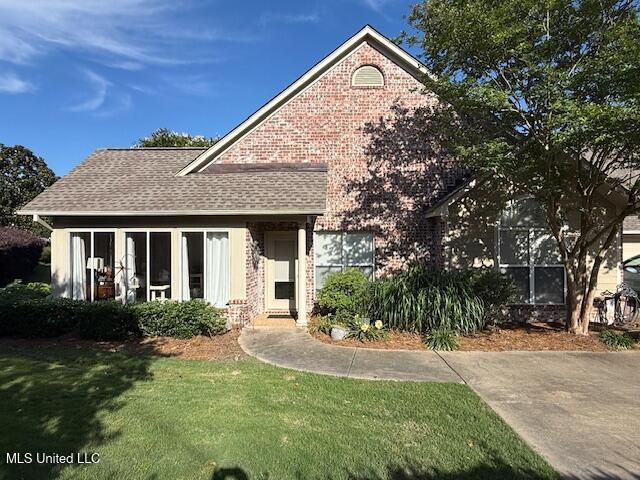 1510 Independence Blvd, Flowood, MS 39232 - view of front facade featuring a front yard, brick siding, and a shingled roof