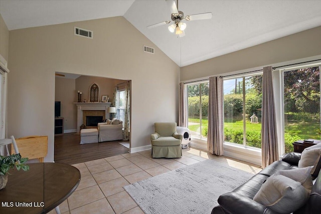 1510 Independence Blvd, Flowood, MS 39232 - living room with a ceiling fan, high vaulted ceiling, a fireplace, light tile patterned floors, and baseboards